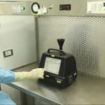 A-cleanroom-operator-performing-non-viable-particle-monitoring